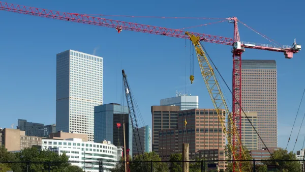 Construction crane in foreground, Denver skyline in background