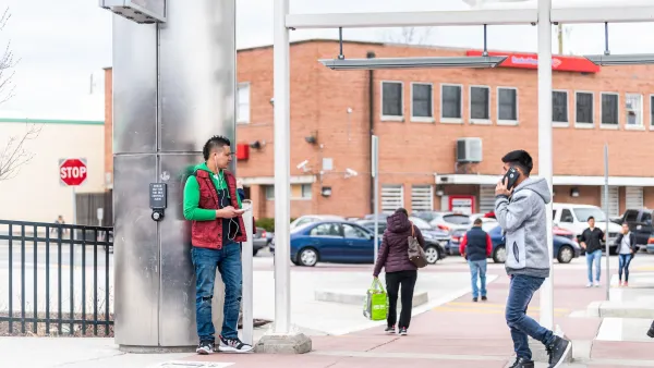 People walking and standing on street in Takoma Park, Maryland in winter clothes.