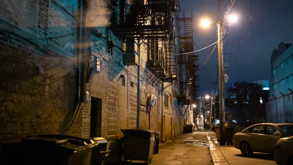 A dark, empty urban alley at night.