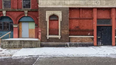 Boarded-up facade of vacant brick building in CIncinnati, Ohio