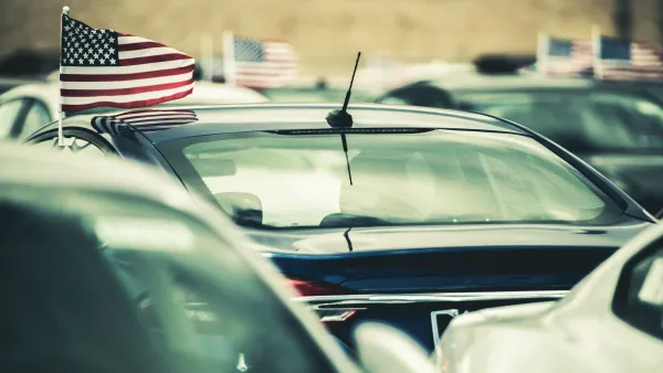 Close-up on cars with small American flags flying above driver side windows.