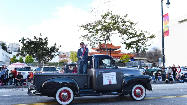 US Representative Jimmy Gomez rides in a black vintage truck in Los ANgeles Chinese New Year parade.