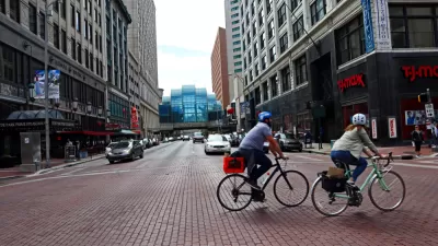 Two bicyclists on a street in downtown Indianapolis, Indiana