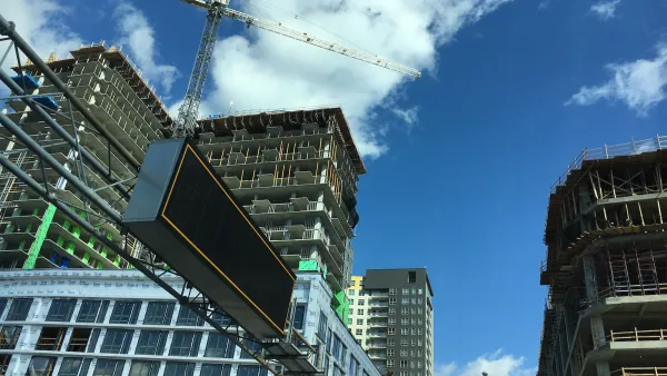 High-rise buildings under construction with crane.