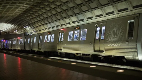 Silver DC Metro train in underground station with high arched ceiling