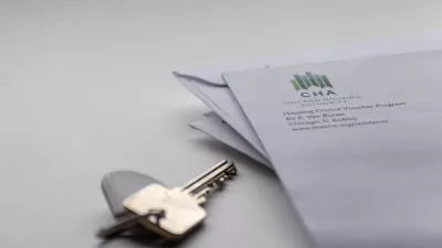 Close-up of house key on table and corner of envelope from Chicago Housing Authority