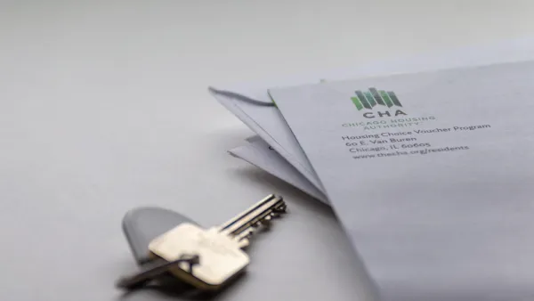 Close-up of house key on table and corner of envelope from Chicago Housing Authority