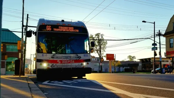 SEPTA bus pulling up to stop against dusk sky in Philadelphia, Pennsylvania.