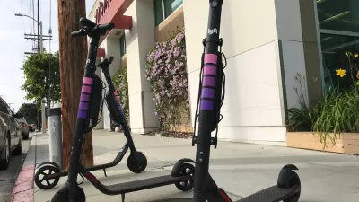 Three Lyft electric scooters parked on a sidewalk in West Los Angeles