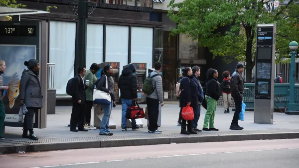 People waiting at bus stop in New York City.