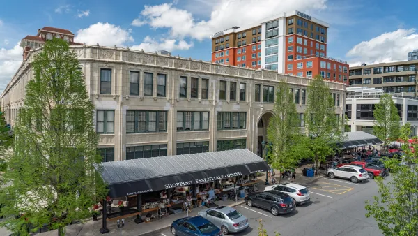 Downtown Asheville, North Carolina with parking lot in foreground next to red brick building.