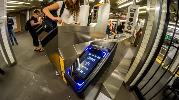 Close-up on OMNY card reader on turnstile at NYC subway station.