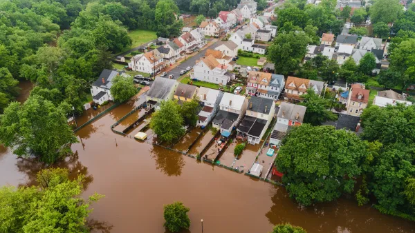 Brown floodwaters in residential neighborhood in New Jersey.