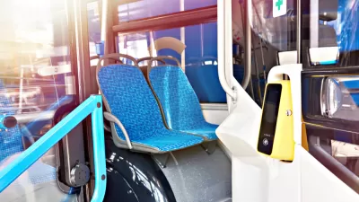 Cashless fare validator on bus with blue seat upholstery