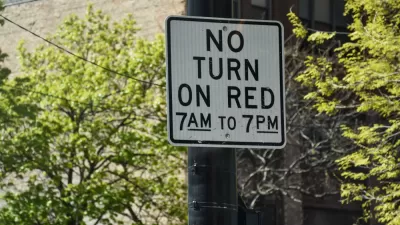 "No right turn on red 7am to 7pm" sign on black post