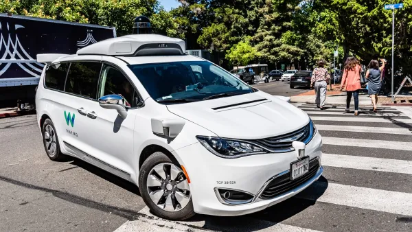 White Waymo robotaxi van.