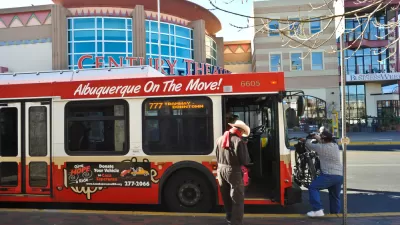 Red Albuquerque bus with man boarding