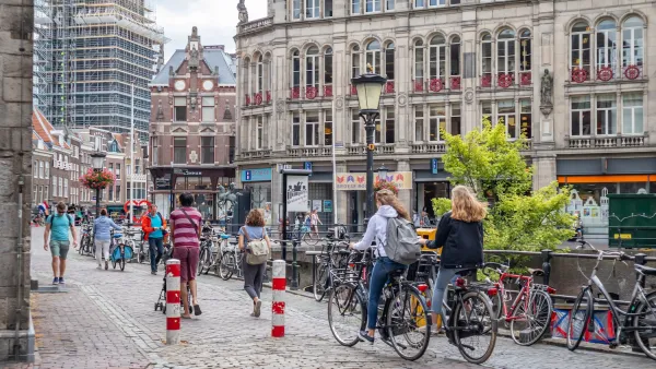 People on bikes on a cobblestone street in Utrecht, Netherlands.