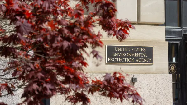 Metal plaque with United States Environmental Protection Agency title on building in Wahsingotn, D.C. with red foliage in the foreground.
