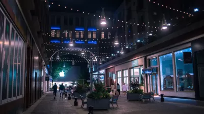 Nighttime view of pedestrianized street in Bethesda, maryland with benches and people walking