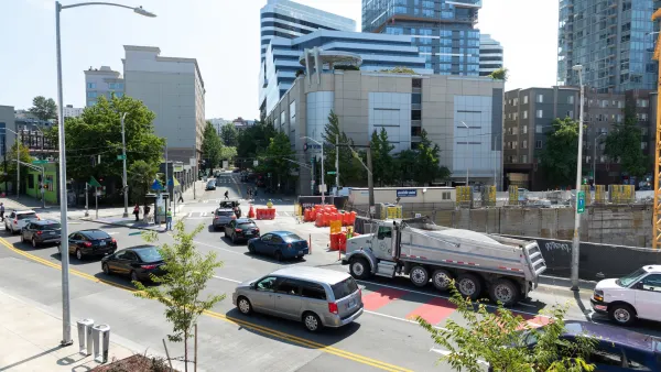 Traffic on Denny Way in Seattle with downtown buildings in background.