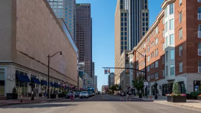 Broad street in downtown Columbus, Ohio with two pedestrians in crosswalk