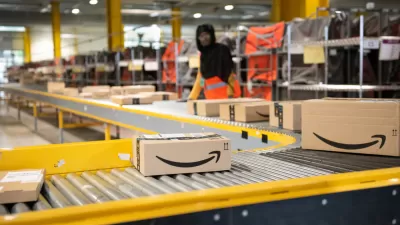 Worker packs boxes in an Amazon warehouse
