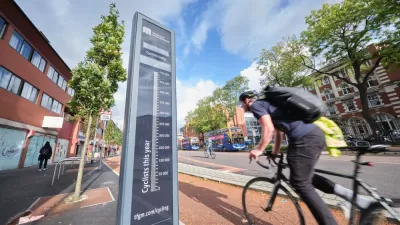 Black bike counter with cyclists passing by on Manchester, UK bike path