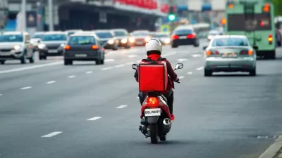 Back view of delivery scooter on roadway