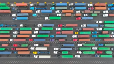 Aerial top-down view of multicolored big rig trucks in lines at the Port of Los Angeles