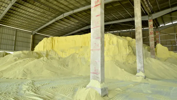 A pile of yellow sulfur in a warehouse