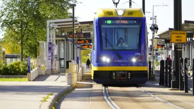 Blue and yellow light rail train pulling into outdoor station in St. Paul, MInnesota