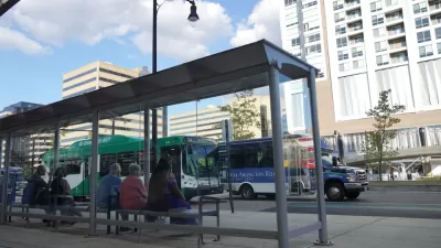 Riders waiting at bus stop in Alexandria, Virginia