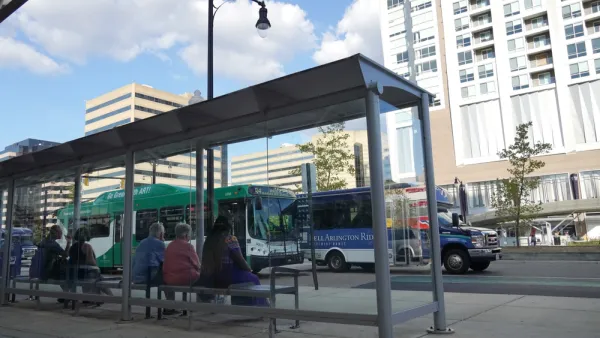 Riders waiting at bus stop in Alexandria, Virginia