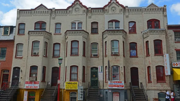 Three-story white brick residential buildings with retail on ground floor/basements in Washington D.C.