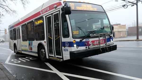 White city bus with red and blue stripes in Philadelphia, Pennsylvania.