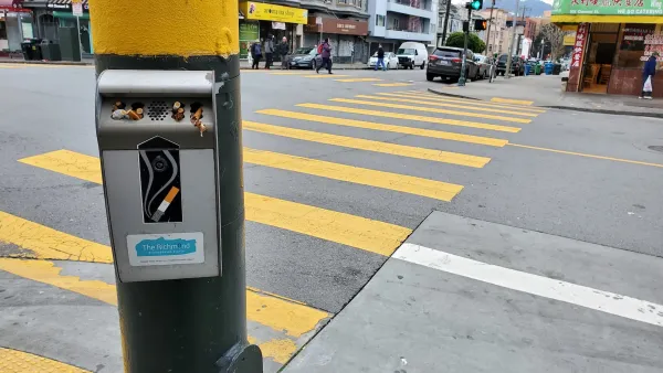 Cigarette disposal box mounted on post on street corner in San Francisco, California.