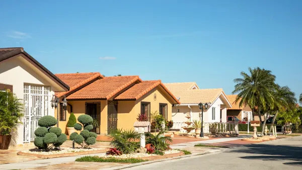 Small Spanish-style homes on residential street in Florida on a sunny day.