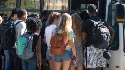 Group of diverse college students boarding crowded bus