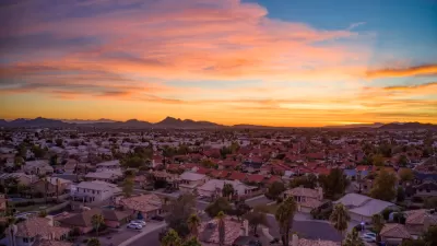 Drone view of colorful sunset over suburban neighborhood in Phoenix, Arizona