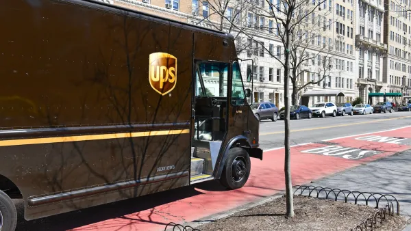 Brown UPS truck stopped in red painted NYC bus lane.