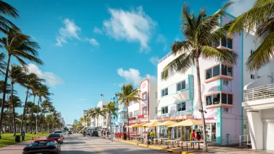 View of Ocean Drive with colorfu three-story buildings and palm trees