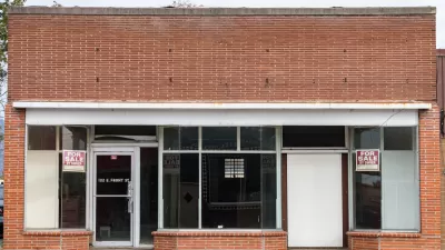 Line of vacant small storefronts with For Sale signs in Merrill, Oregon