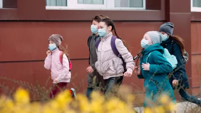 Group of children dressed warmly and wearing COVID-19 masks