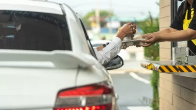 Driver reaching for chagne at drive-through window
