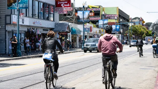 People ride bikes on street in San Francisco, California.