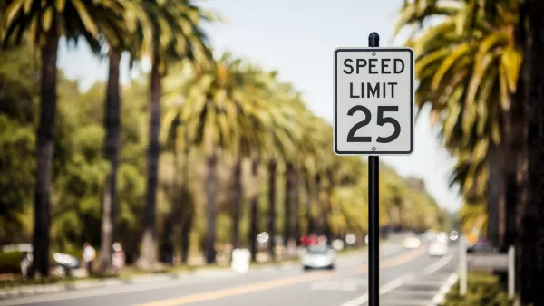 25mph speed limit sign with blurred street with car and palm trees in background 