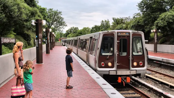 Arlington Cemetery train station platform with woman and young boys waiting as train pulls in.