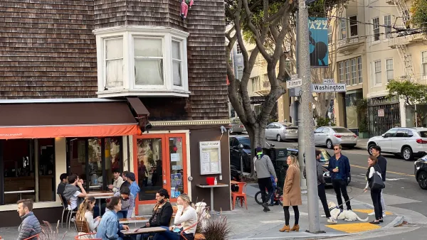 People dining at outdoor tables in temporary setups during or after pandemic in San Francisco, California.