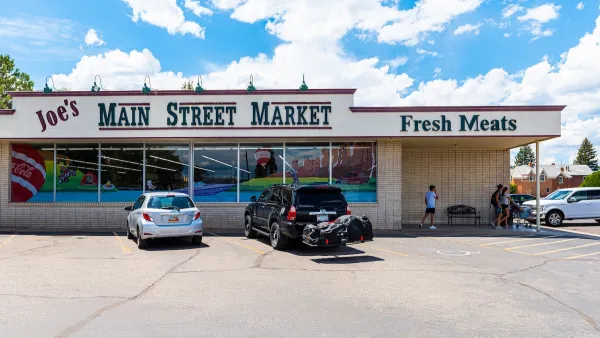 Small town market with "Main Street Market" and "Fresh Meats" signs in green letters.